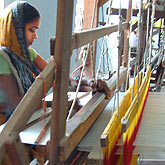 

   A weaver creating the fabric on a handloom   
.
