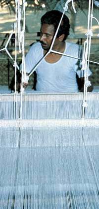 

   Weaver at his loom   
.
